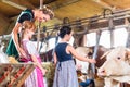 Bavarian mother showing children cows in cowhouse Royalty Free Stock Photo