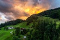 Bavarian Mountain Landscape with Meadows, Forest, Cabin and Alps during dramatic Sunset, Germany Royalty Free Stock Photo