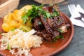 Bavarian pork ribs baked with sauce with boiled potatoes and sauerkraut Royalty Free Stock Photo