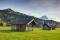 Bavarian rural scenery of timber barns, meadows and mountains Royalty Free Stock Photo