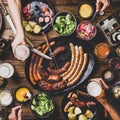 Bavarian sausages, snacks and beers for Octoberfest dinner, square crop