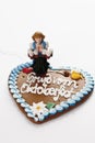 Bavarian waitress figurine holding beer stein standing on gingerbread heart