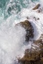 Foamy waves of the surf near the rocky shore