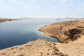 a stone sandy coast in the desert. the seashore in Sharm el sheikh egypt. Bay with blue water in Ras Muhammad National Park