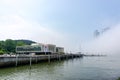 The Bay 101 building with waterfront view cover by large thick mist blow from the sea pass through skyscrapers in Haehundae, Busan