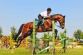 Bay horse and rider over a jump Royalty Free Stock Photo