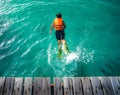 A bay jump from wooden bridge to the sea for swimming Royalty Free Stock Photo