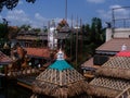 Ornate tiled building with sculptural details of traditional East Asian undergoing repairs