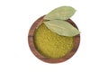 Bay leaf powder in a wooden spoon isolated on white background. Dry bay leaf. Bay leaf spice. Royalty Free Stock Photo