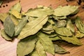 Bay leaf on a wooden background. Garlic and pepper in a pot. View from above. Seasoning flavoring for meat and food.