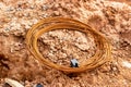 A bay of rusty steel tie-wire climbs on the ground at a construction site Royalty Free Stock Photo