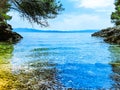 Bay by the sea on a pebble beach. Sea coast with clear blue water on a sunny bright day in summer Royalty Free Stock Photo