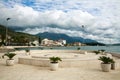Bay in seaside town with boats, houses in green mountains on blue sky.Tivat, Montenegro Royalty Free Stock Photo