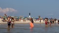 A Group of People Enjoying a Day at the Beach with the Fire Island Light House in the background Royalty Free Stock Photo