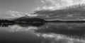 Bay waterscape with reflections in monochrome Royalty Free Stock Photo