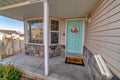 Bay window pastel green front door and open porch at the facade of charming home Royalty Free Stock Photo