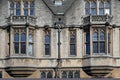 bay windows look out onto the street from one of the ancient Oxford colleges