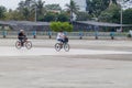 BAYAMO, CUBA - JAN 30, 2016: Cyclists cross the Plaza de la Patria Fatherland Sqaure in Bayamo, Cub