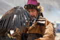 Bayan-Olgii, Mongolia - October 01, 2017: Golden Eagle Festival. Portrait Of Mongolian Hunter With Expressive Sight Prepares A Gol