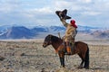 Unknown huntsman with Golden Eagle shows his experience in falconry.