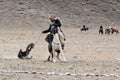 Unknown huntsman with Golden Eagle shows his experience in falconry.