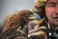 BAYAN-OLGII PROVINCE, MONGOLIA - OCT. 01, 2017: Traditional Golden Eagle Festival. Unknown Mongolians Hunter Berkutchi With G