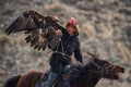 Bayan-Ulgii, Mongolia - October 01, 2017: Golden Eagle Festival. Impressive Mongolian Hunter In Traditional Clothes Astride A Hors