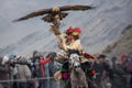 Bayan-Ulgii, Mongolia - October 01, 2017: Golden Eagle Festival. Triumphant Mongolian Hunter Berkutchi In Traditional Clothes Ridi