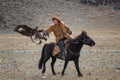 Bayan-Ulgii, Mongolia - October 01, 2017: Golden Eagle Festival.Unknown Mongolian Hunter So Called Berkutchi Astride On Brown Royalty Free Stock Photo