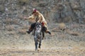 Bayan-Ulgii, Western Mongolia,Golden Eagle Festival, October 01, 2017: Mongolian Rider-Hunter In Traditional Clothes Of Wolf Fur Royalty Free Stock Photo