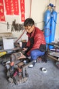 Bayi man making a silver pot. Heqing is famous for the artigianal production of Silver tools Royalty Free Stock Photo