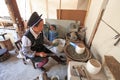 Bayi woman making a silver pot. Heqing is famous for the artigianal production of Silver tools Royalty Free Stock Photo