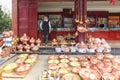 Bayi woman selling silver pots. Heqing is famous for the artigianal production of Silver tools Royalty Free Stock Photo