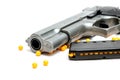 BB Gun, Old Airsoft Pistol Toy and Magazine with BB Gun Bullets on White Background