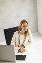 Bbeautiful businesswoman working on laptop in bright modern office Royalty Free Stock Photo