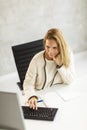 Bbeautiful businesswoman working on laptop in bright modern office Royalty Free Stock Photo