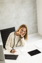 Bbeautiful businesswoman working on laptop in bright modern office Royalty Free Stock Photo