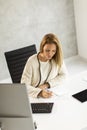 Bbeautiful businesswoman working on laptop in bright modern office Royalty Free Stock Photo