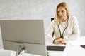 Bbeautiful businesswoman working on laptop in bright modern office Royalty Free Stock Photo