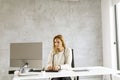 Bbeautiful businesswoman working on laptop in bright modern office Royalty Free Stock Photo