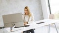 Bbeautiful businesswoman working on laptop in bright modern office Royalty Free Stock Photo