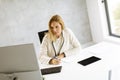 Bbeautiful businesswoman working on laptop in bright modern office Royalty Free Stock Photo