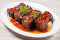 bbq beef ribs glazed in tangy sauce on a white plate