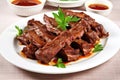 bbq beef ribs glazed in tangy sauce on a white plate