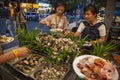 BBQ cafe, sea food, cooking seafood on a barbecue, shrimps, oysters, frog legs, squids, close-up