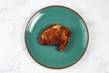 bbq chicken breast piece served in a dish isolated on background side view