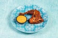 bbq chicken leg piece served in a dish isolated on background side view