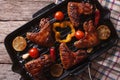 BBQ chicken wings with vegetables in a pan close-up. horizontal Royalty Free Stock Photo