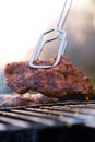 Bbq closeup with metal tongs Royalty Free Stock Photo