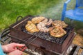 BBQ. Cooking barbecue steak and sausages on the old grill in the backyard in the summer day. Close up